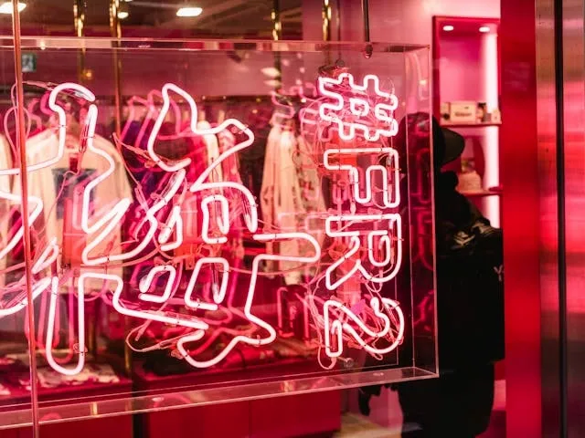 an attractive neon light display in a store window for how to attract customers to your store