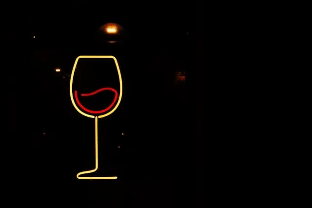 a neon sign depicting a wine glass for party lighting ideas