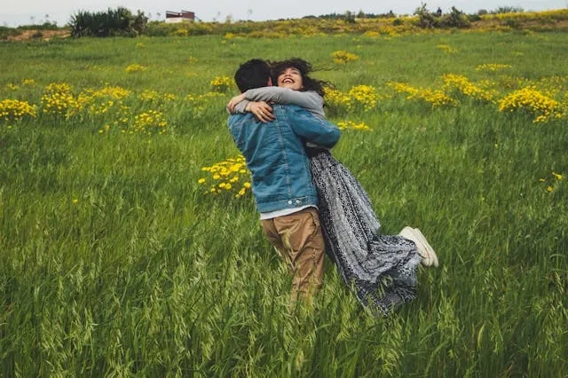 a man wearing a denim jacket while hugging someone for what to wear with denim jacket male