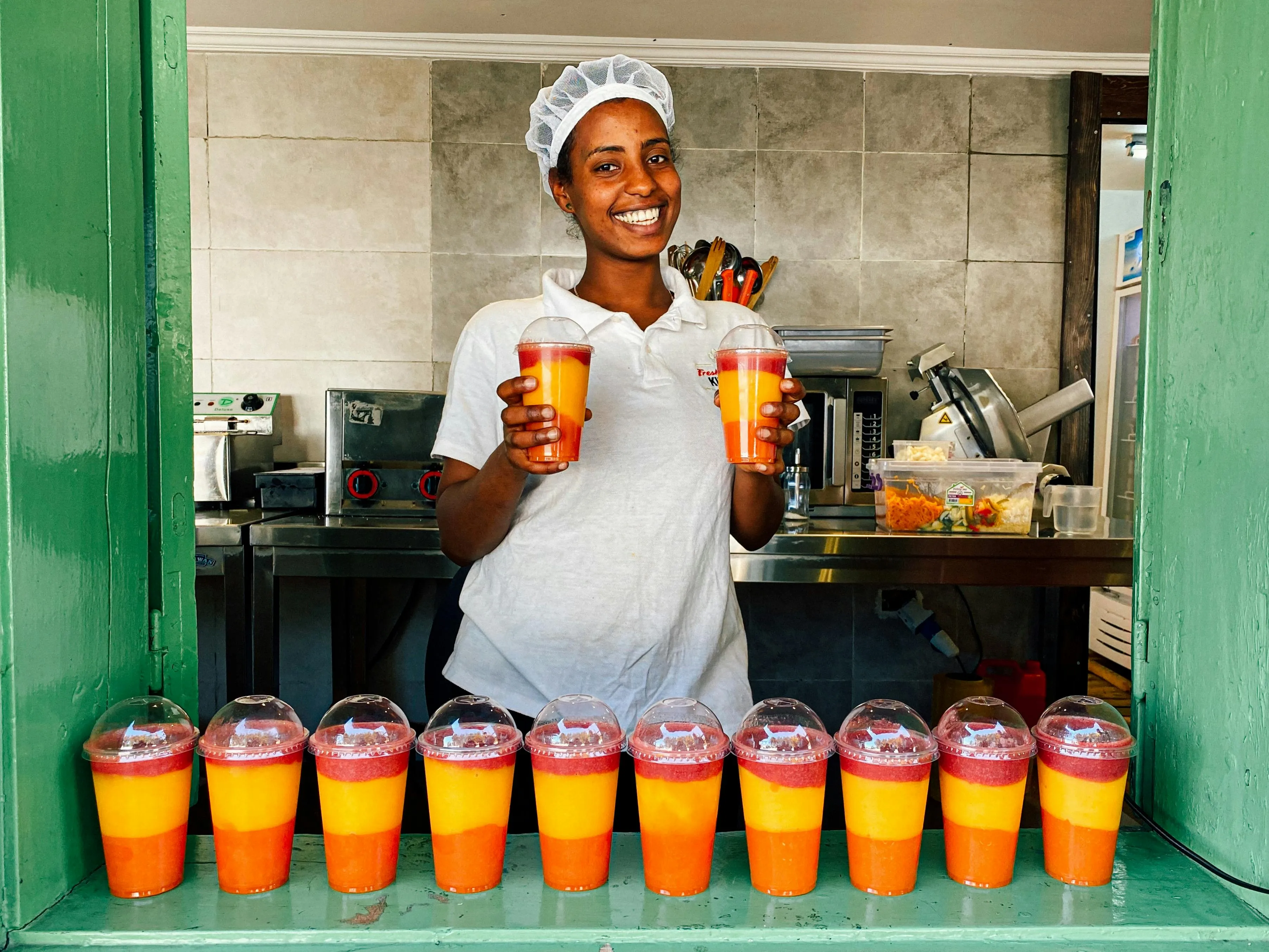 a person at a bar with a selection of smoothies for what equipment do you need to start a juice bar