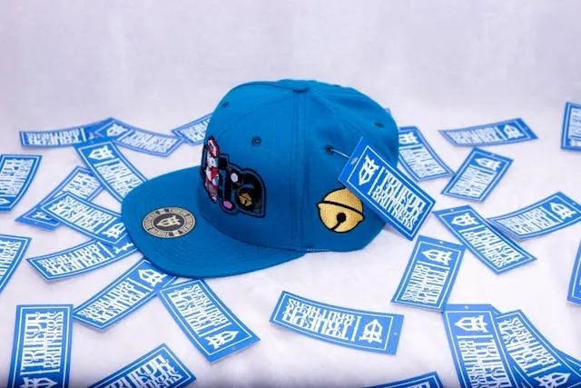 a blue baseball cap with patches for iron patch onto hat