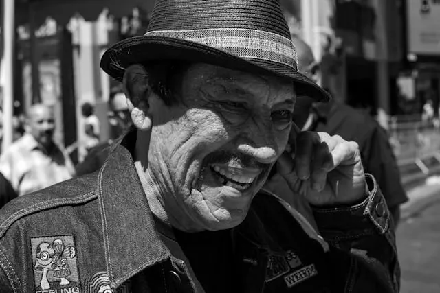 a black and white photo of danny trejo wearing a patched jacket for how to put a patch on a jacket