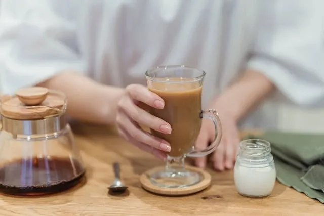 a hand on a glass of coffee that is on a coaster for coffee coaster ideas