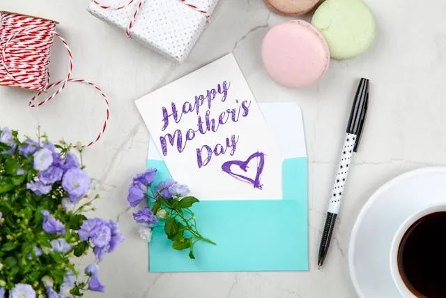 a happy mothers day card beside a pen and other items for mothers day coaster ideas