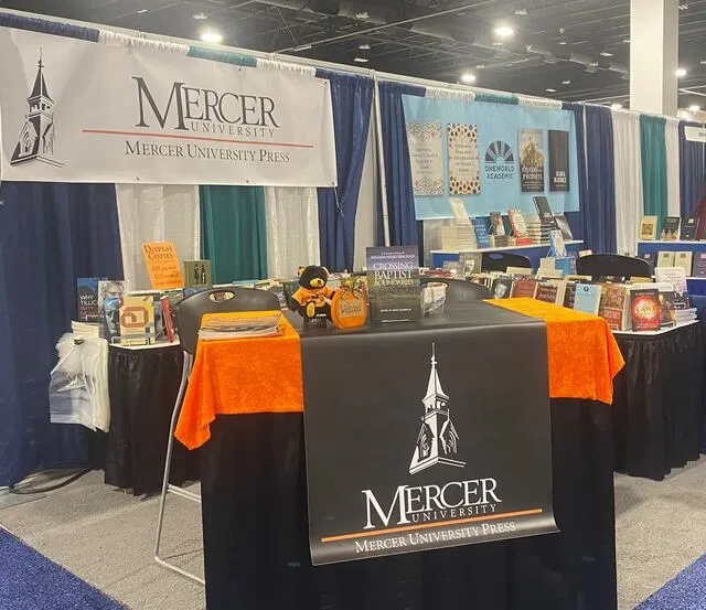 a trade show booth with a branded table runner for trade show marketing