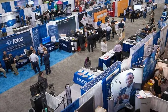 an overhead view of a busy trade show for what is a trade show