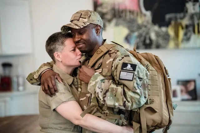 a man and a woman in military uniforms embracing with patches on show for army patches meaning