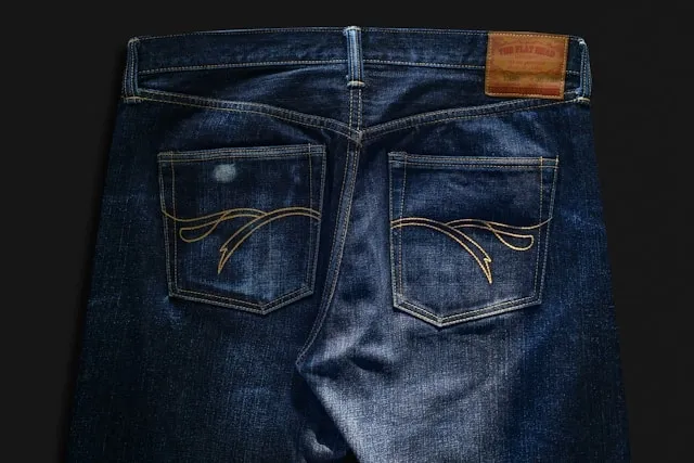 a pair of jeans against a dark background for how to patch jeans crotch