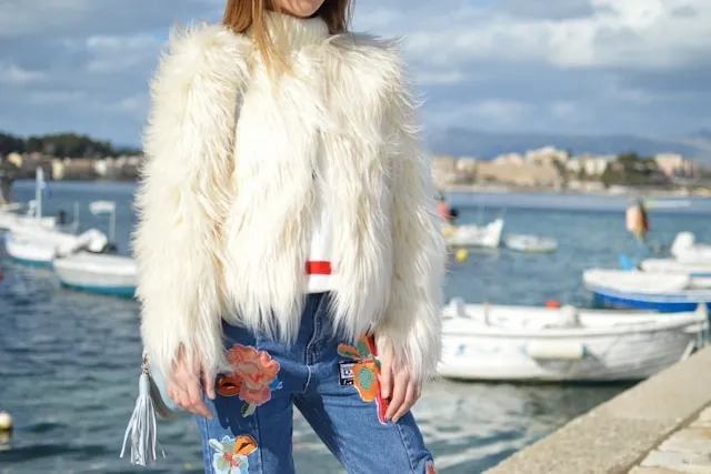 a woman wearing jeans with patches for how to patch jeans crotch