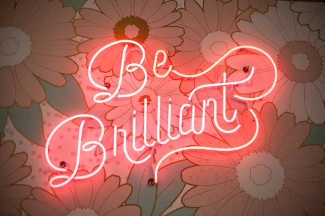 a red neon sign that says be brilliant in elaborate script font for aesthetic neon quotes