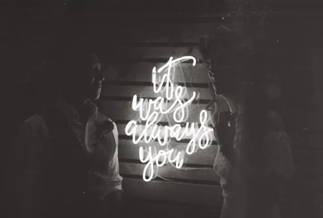 a black and white image of a bride and groom in front of a neon sign for what size neon sign for wedding