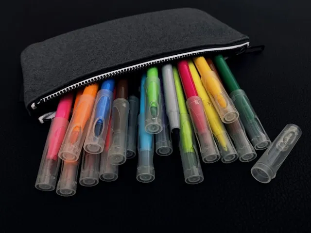 coloring pens spilling out of a black case for best gel pens for coloring