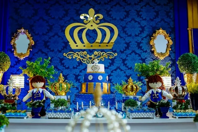 a decorative cake table with a blue and gold color palette for cake table decoration ideas