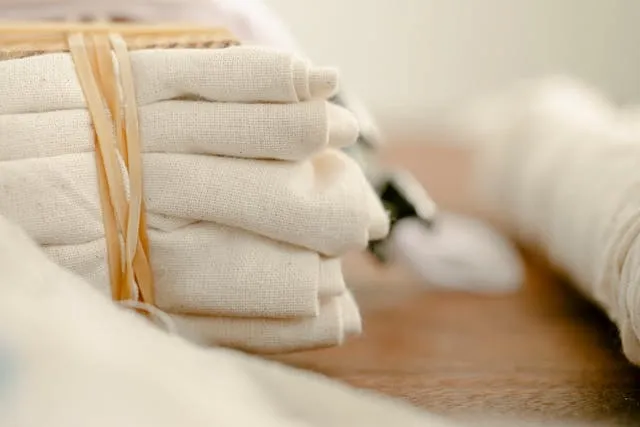 a stack of folded tablecloths for tablecloth storage ideas