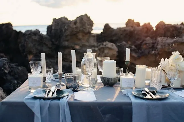 an outdoor dining table decorated with candles for low-cost wedding table decorations