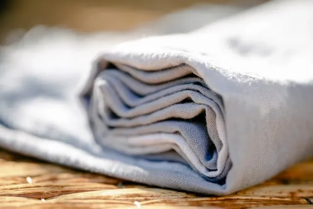 close up of partially rolled linen for tablecloth storage ideas