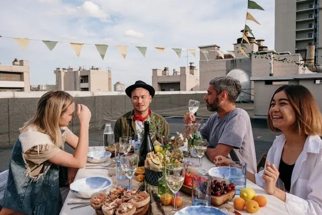 a group of people enjoying a rooftop dinner party for elegant table setting ideas