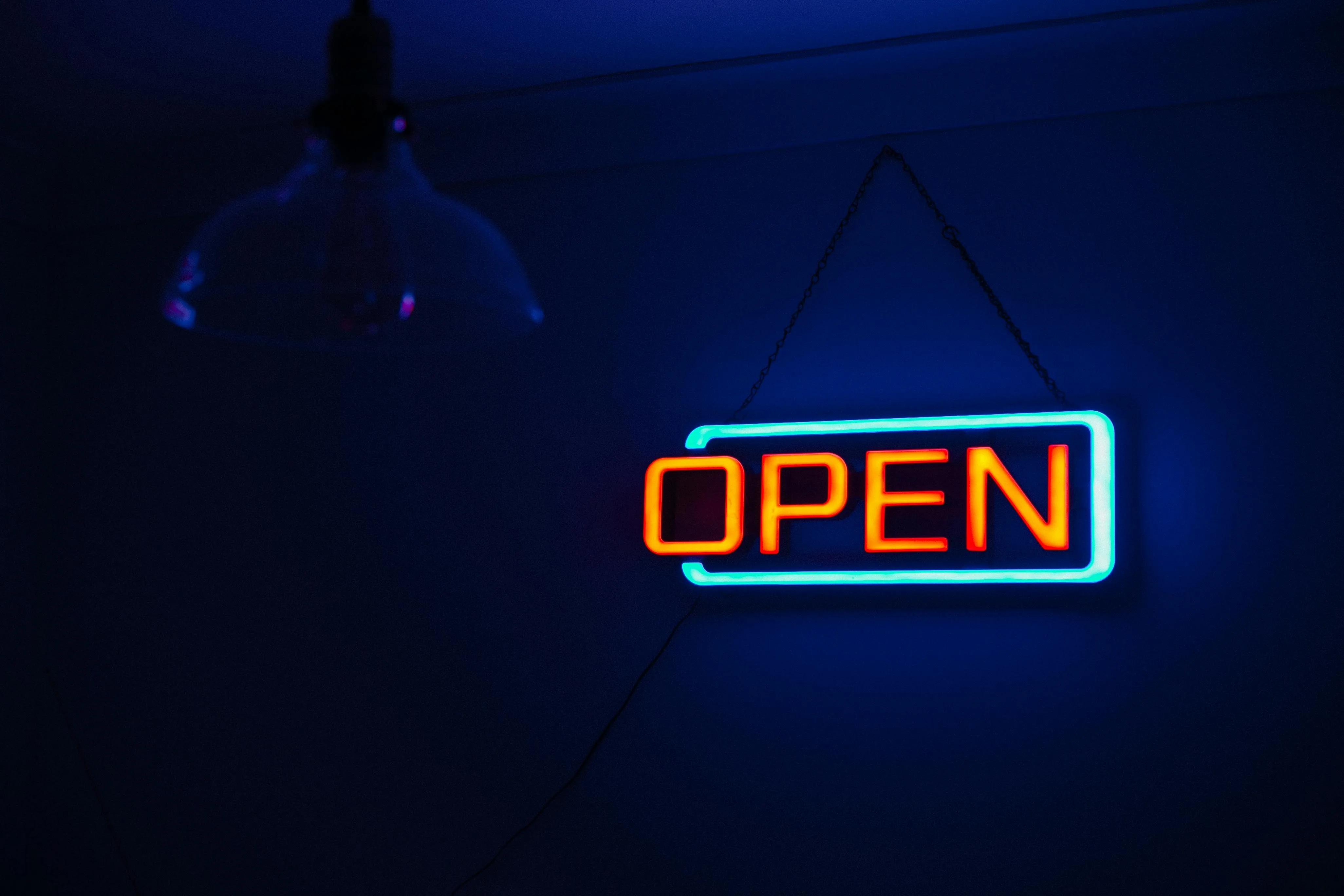 a neon open sign in a dark environment for why is neon used in advertising signs