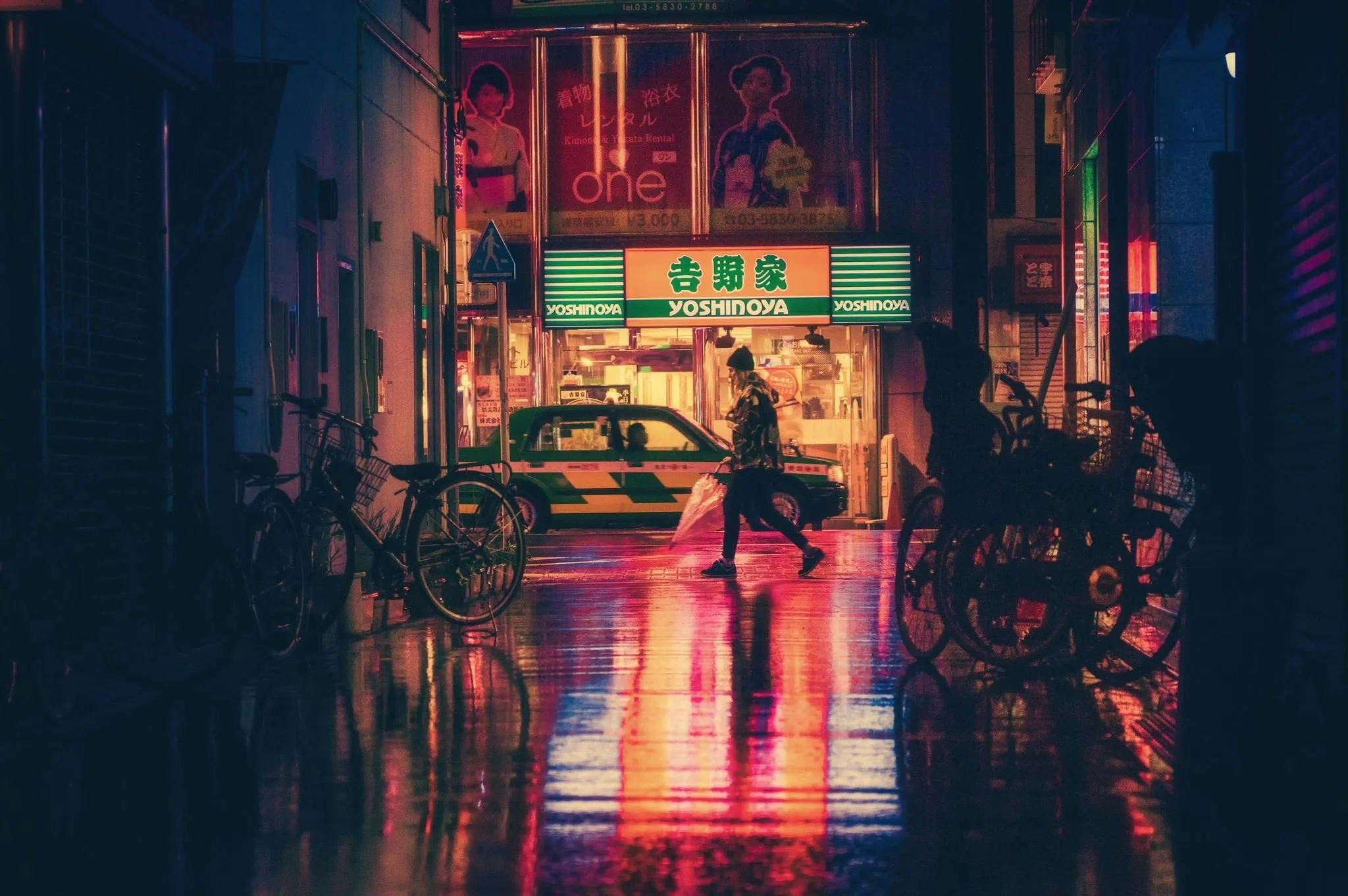 a street at night illuminated by neon signage for why is neon used in advertising signs