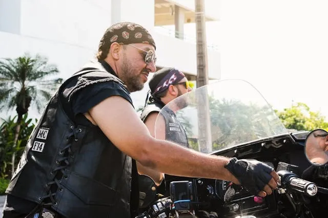 a biker wearing a leather vest and bandana for motorcycle patches to avoid