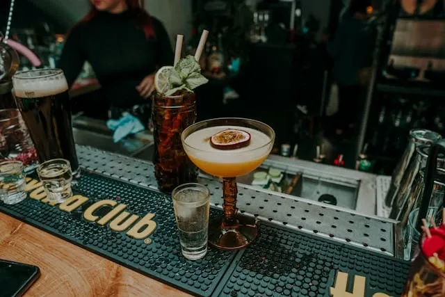 a bartop with drinks on a green bar mat for what are bar mats for