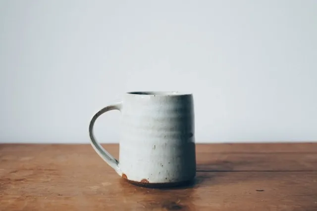 a rustic ceramic mug on a wooden table for what is a mug rug