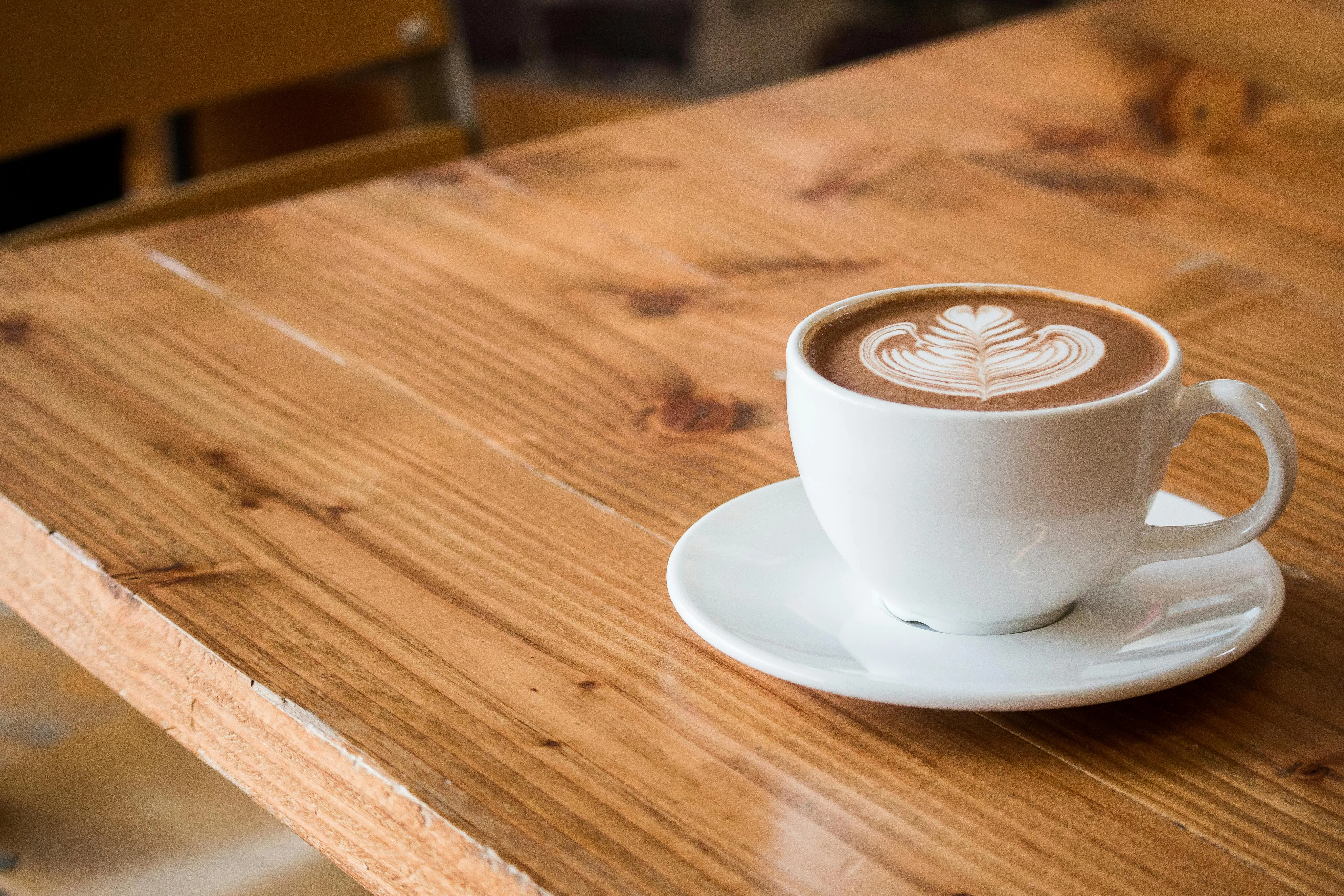 a mug of coffee on a wooden tabletop for rustic bar ideas