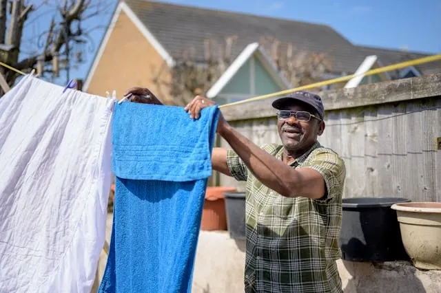 a man hanging laundry outdoors for are vinyl tablecloths machine washable a man hanging laundry outdoors for are vinyl tablecloths machine washable
