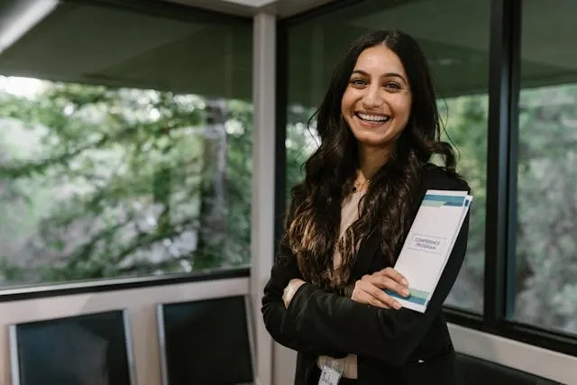 a woman smiling for trade show planning a woman smiling for trade show planning