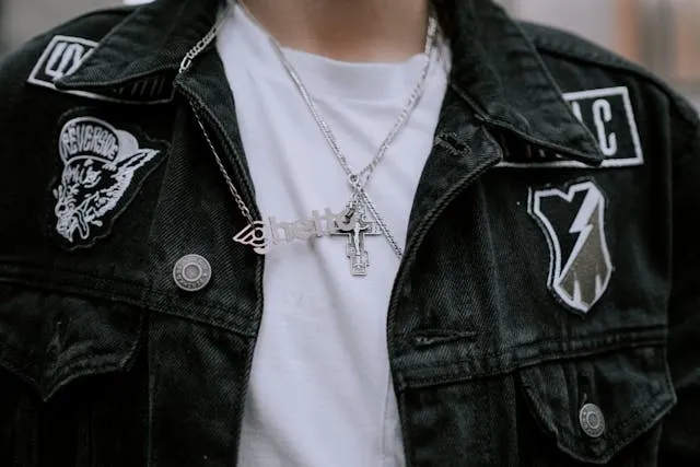 a person wearing a black denim jacket with patches for how to display patches