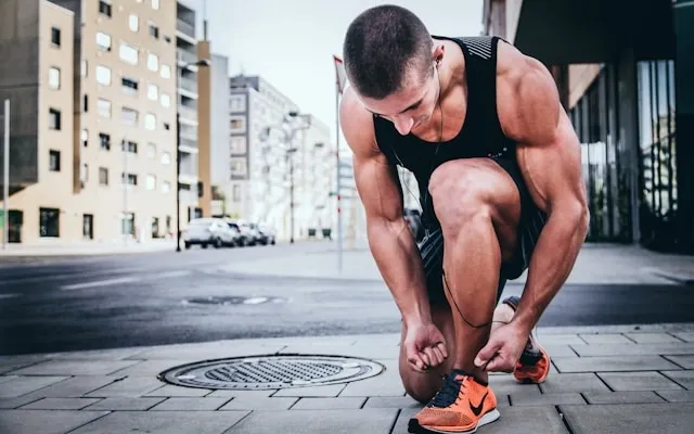 a runner tying his shoelace for do neck fans work a runner tying his shoelace for do neck fans work