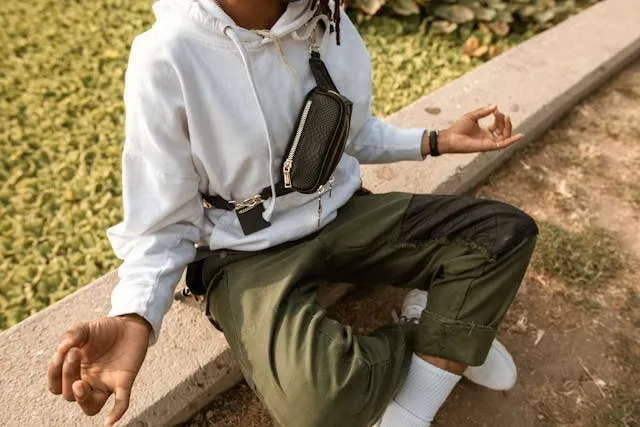 a person meditating outdoors for are fanny packs back in style