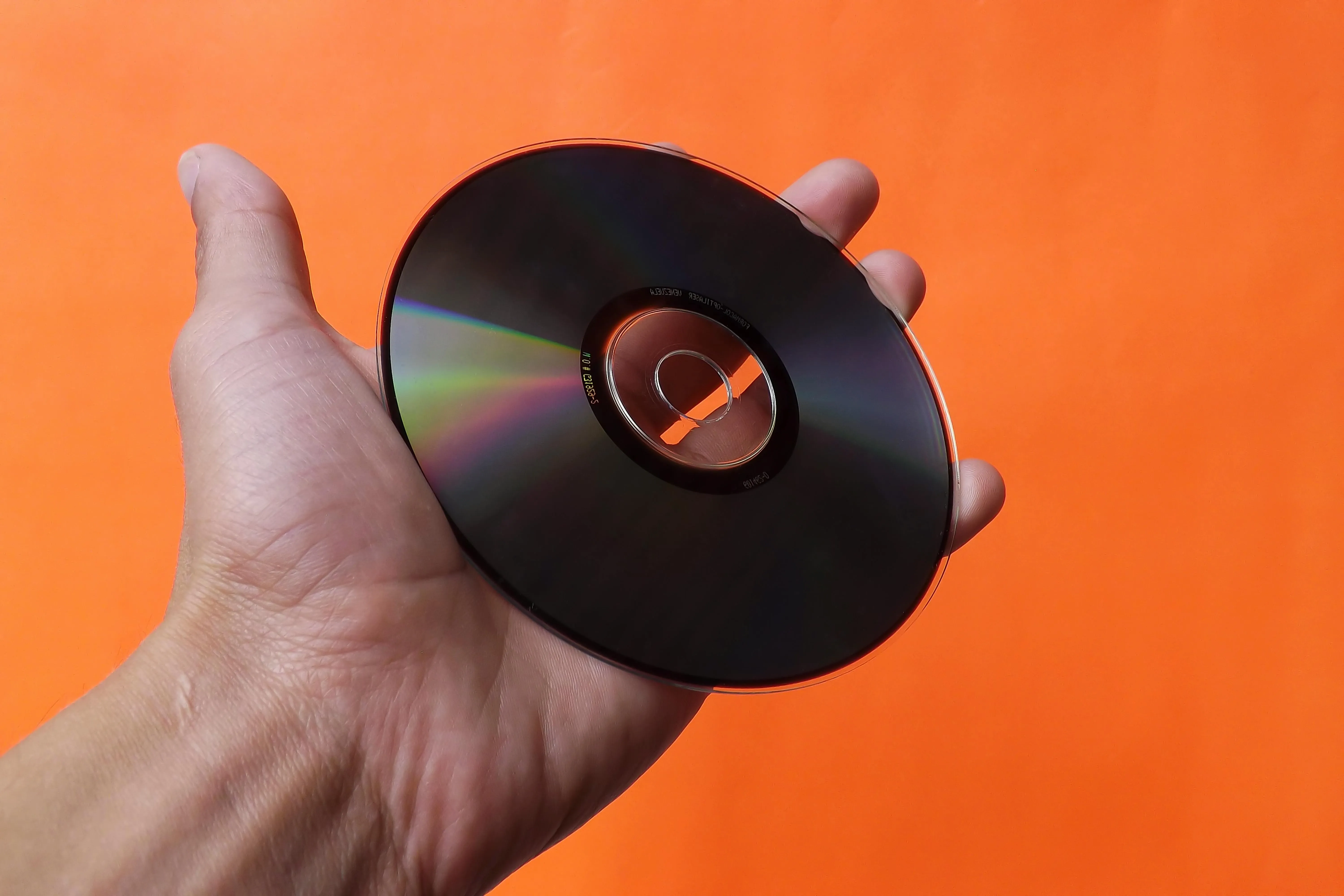 a hand holding a cd for cd coasters a hand holding a cd for cd coasters