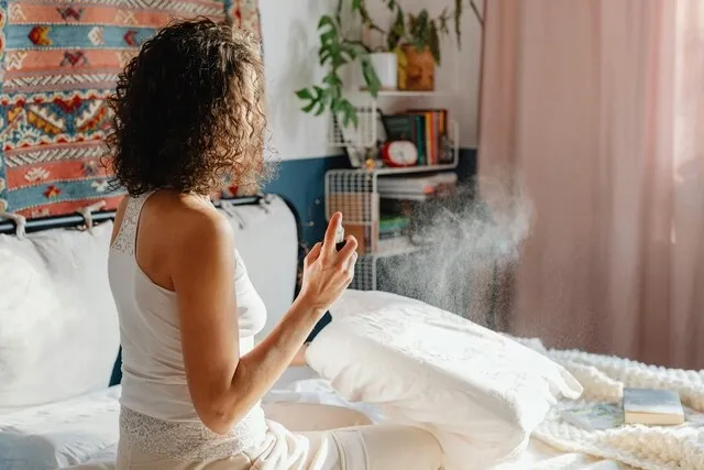 a woman using a room spray for how do air fresheners work a woman using a room spray for how do air fresheners work