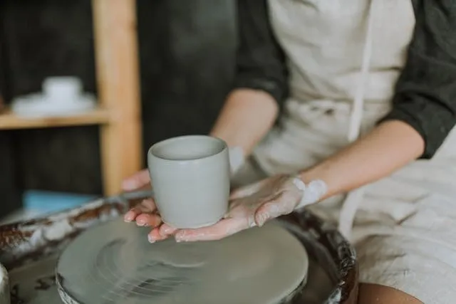 a person holding a wet clay pot for are ceramic mugs microwave safe a person holding a wet clay pot for are ceramic mugs microwave safe