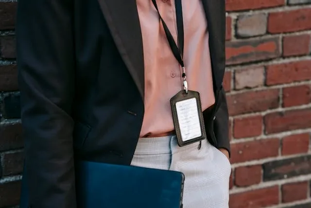 a person with an ID badge and a laptop for how to make badge holders a person with an ID badge and a laptop for how to make badge holders