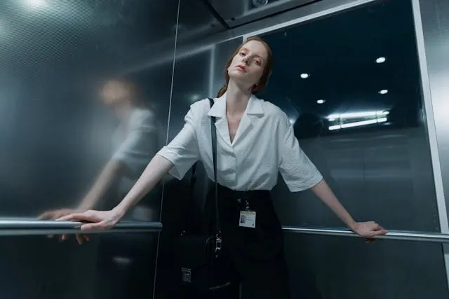 a woman in a white shirt inside an elevator for how to make badge reels a woman in a white shirt inside an elevator for how to make badge reels