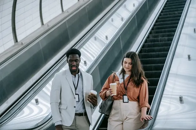 a man and a woman with id badges on an escalator for how to make badge holders a man and a woman with id badges on an escalator for how to make badge holders