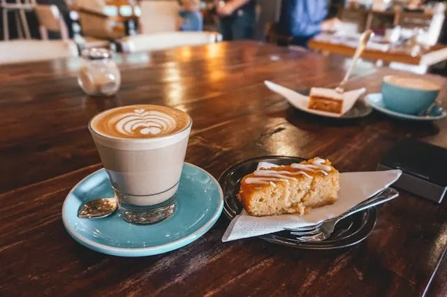 an espresso on a table beside a cake for best glass coffee mugs