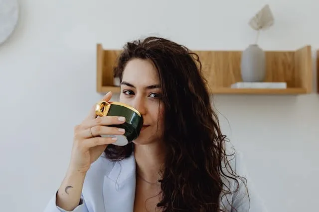 a woman drinking from a cup for porcelain vs ceramic mugs