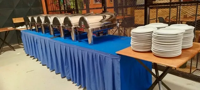 a buffet table with blue table skirt for skirted table