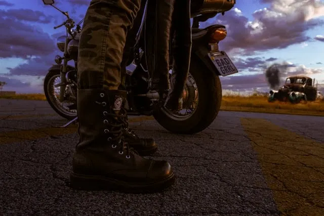 a person wearing black leather boots for 13 1/2 patch a person wearing black leather boots for 13 1/2 patch