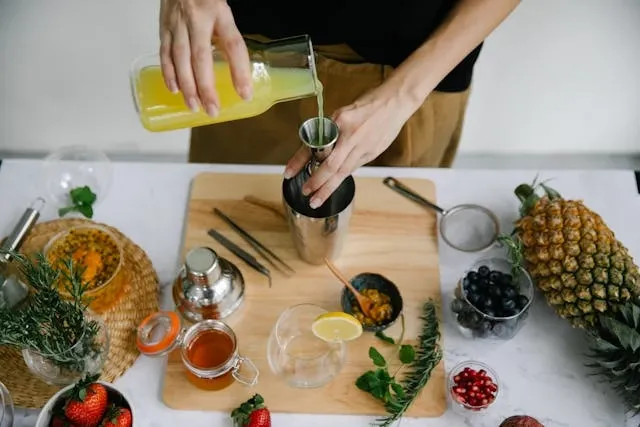 a person pouring fruit juice for essential bar tools a person pouring fruit juice for essential bar tools