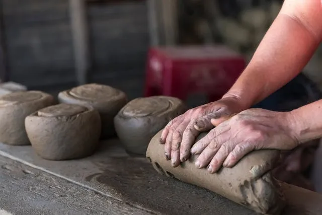 a person molding brown clay for clay coasters a person molding brown clay for clay coasters