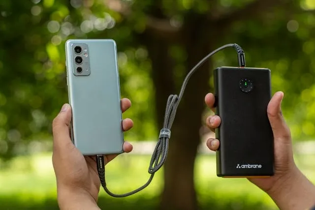 hands holding a smartphone and power bank for backpack with usb charging port how to use hands holding a smartphone and power bank for backpack with usb charging port how to use
