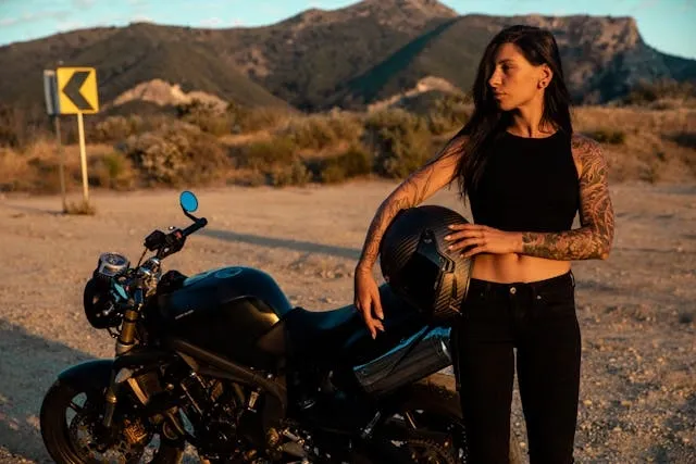 a woman standing beside a motorbike for motorcycle vest patches rules a woman standing beside a motorbike for motorcycle vest patches rules