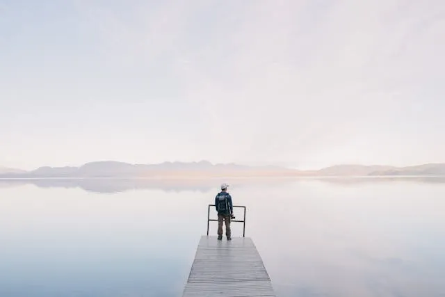 a man standing on wooden docks for how to waterproof a backpack a man standing on wooden docks for how to waterproof a backpack
