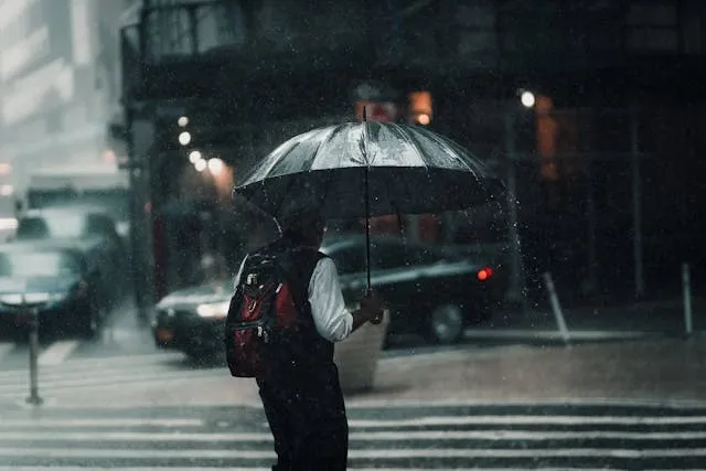 a man in a downpour in the city for how to waterproof a backpack a man in a downpour in the city for how to waterproof a backpack