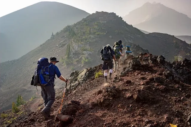 a group of people hiking for how to attach sleeping bag to backpack a group of people hiking for how to attach sleeping bag to backpack