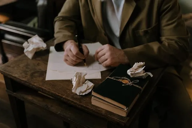 a person writing on white paper for how to get ink out of clothes a person writing on white paper for how to get ink out of clothes